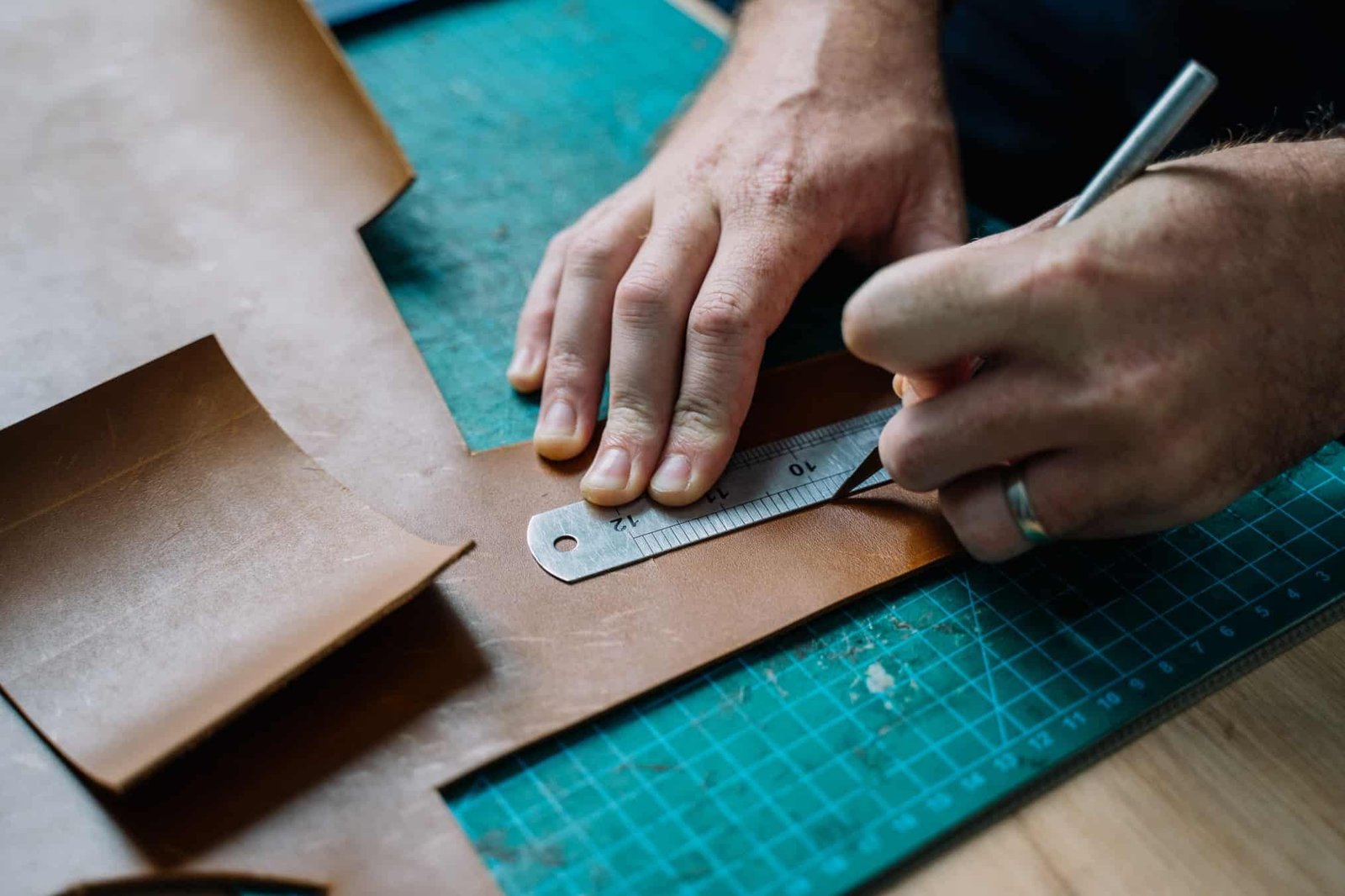 DIY bag kit materials laid out on a table including pre-cut leather pieces and tools